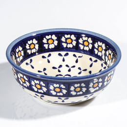 small muesli bowl with white and yellow flowers on blue